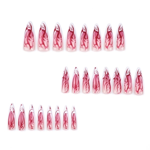 Long almond press-on nails featuring red flame patterns and abstract pink marble design