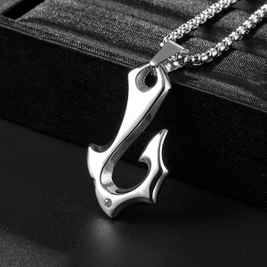 Detailed macro view of silver fish hook pendant with small diamond and box chain