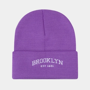 Detail of purple knit beanie with white Brooklyn EST 1631 embroidery and ribbed texture
