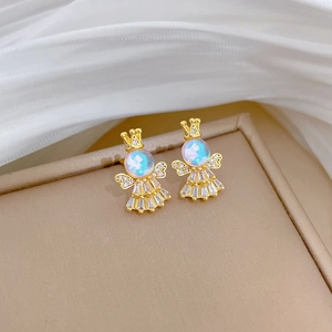 Close-up of gold crown angel earrings with iridescent gems and micro-inlaid crystals