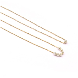 Detail view of 18K gold plated titanium choker with curved imitation pearl pendants