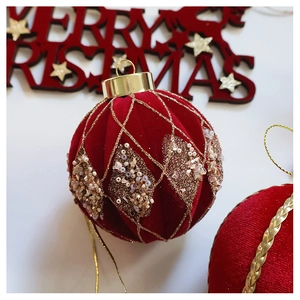 Macro view of velvet Christmas ornament with gold glitter grid and champagne pearl beadwork