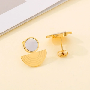 Macro view of gold hoop earrings featuring white shell inlay and ribbed fan-shaped detail
