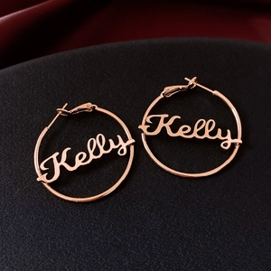 Detailed view of custom 18K gold plated hoop earring featuring Kelly name cutout design