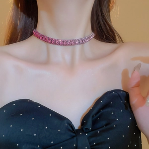 Close-up of sparkling pink crystal choker necklace on neck with elegant metal details