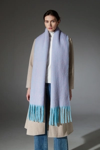 Detail of soft lilac and pink knit scarf with contrasting blue tassel fringe texture