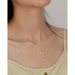Elegant gold S925 silver necklace with teardrop crystal pendant on female model