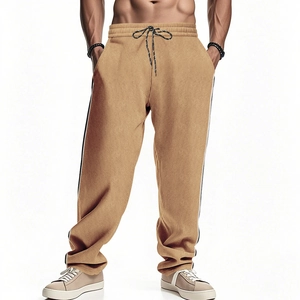 Detail view of khaki corduroy pants showing drawstring waist and side stripe texture