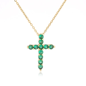 Elegant gold cross necklace featuring eleven round green cubic zirconia in a claw setting