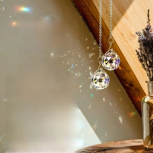 Macro shot of faceted crystal suncatchers casting rainbow patterns near a window