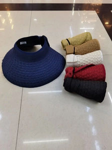 Foldable straw sun visors shown in various colors for convenient travel storage