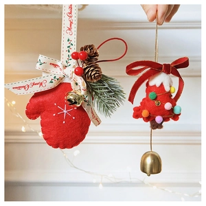Detail of wool felt Christmas ornaments with pine cones, golden bells and red bows