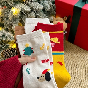 Detail of Christmas cotton socks with festive patterns and hand-held presentation