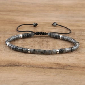 Detail view of emperor stone beaded bracelet with adjustable black braided rope and metal spacers