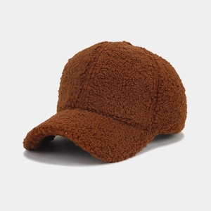 Detailed texture of brown sherpa fleece fabric on a winter curved brim baseball cap