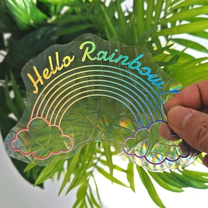 Holographic suncatcher sticker with cloud design and Hello Rainbow text on glass