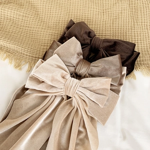 Vintage velvet bow hair clips in brown and beige tones for elegant women's hairstyles