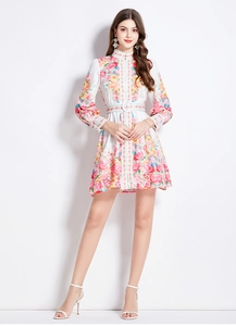 Detailed close-up of retro floral dress with stand collar and lantern sleeves on model