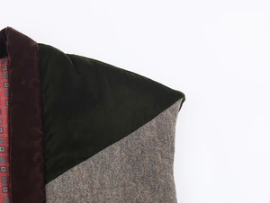 Macro shot of patchwork velvet and tweed vest showing rich texture and geometric lining