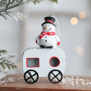 Christmas snowman in white carriage hanging ornament with festive background lights
