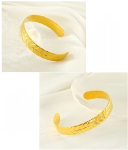 Macro detail of golden wheat ear pattern on adjustable stainless steel cuff bangle