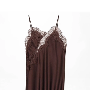 Deep brown satin slip dress featuring elegant eyelash lace trim and irregular hemline