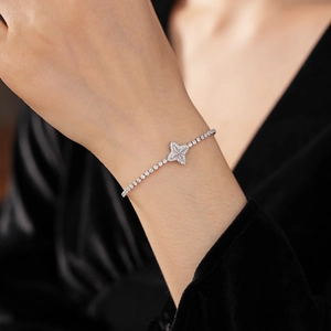 Detail of adjustable silver flower bracelet with sparkling zircons on a model wrist