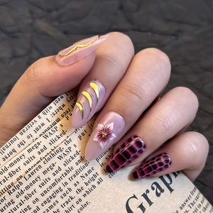 Detailed view of pink Y2K press-on nails with crocodile texture and golden 3D flower embossing
