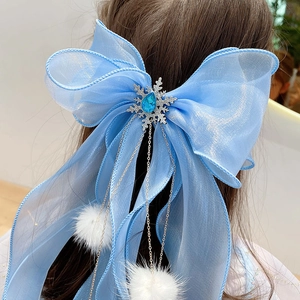 Blue organza hair bow with silver snowflake jewel and white faux fur pompom tassels