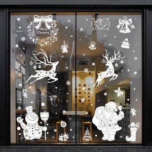 White Christmas window decals featuring Santa, snowman, and reindeer on glass storefronts