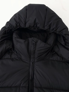 Close-up of black hooded puffer jacket showing zipper and quilted texture detail