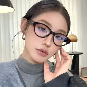 Vintage cat-eye blue light blocking glasses in deep brown worn by a model at home