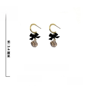 Detailed shot of bow earrings with zircon drop and S925 silver needle on white background