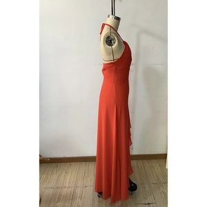 Detail of elegant deep red halter neck long dress with ruffled layers and open back design