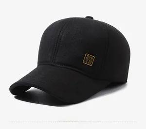 Detail view of thickened black wool baseball cap with golden metallic side emblem