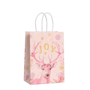 Pink Christmas kraft paper gift bag with white rope handles and artistic JOY lettering