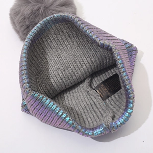 Metallic purple knit beanie with grey faux fur pompom and warm acrylic lining