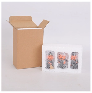 Halloween pumpkin devil figurines packed in protective foam and brown cardboard shipping box