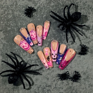 Halloween press-on nails in long coffin shape with ghost and pumpkin nail art designs