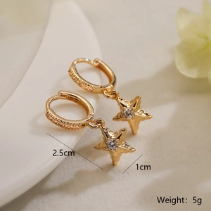 Detailed view of gold star earrings with cubic zirconia and dimensions 2.5cm long