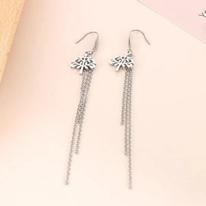 Macro shot of silver tree pendant earrings with delicate cascading multi-chain tassels