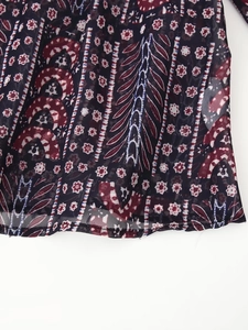 Close-up of lightweight paisley fabric with intricate geometric and floral prints