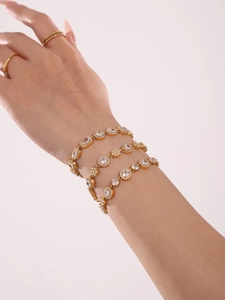 Macro detail of 18K gold-plated bracelets featuring high-grade 5A cubic zirconia stones