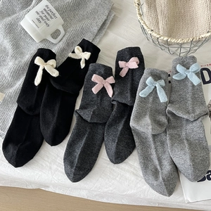 Three pairs of wool blend mid-calf socks with cute knit bows in black and grey tones