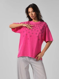 Close-up of pink cotton T-shirt with black H letter print and vintage washed texture