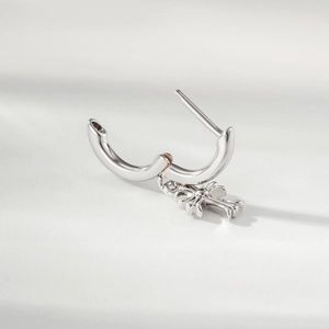 Silver hoop earrings with cross pendant and gold accents in minimalist design