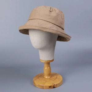 Detail view of khaki washed cotton bucket hat with wide brim on a display mannequin