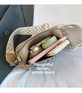 Crossbody square bag interior showing storage space for phone, makeup, and notebook