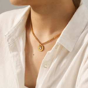 18k gold-plated stainless steel horseshoe pendant necklace with zircon on a model