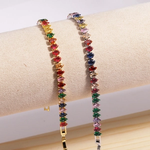 Detail of 18K gold plated bracelets featuring rainbow cubic zirconia in teardrop cuts